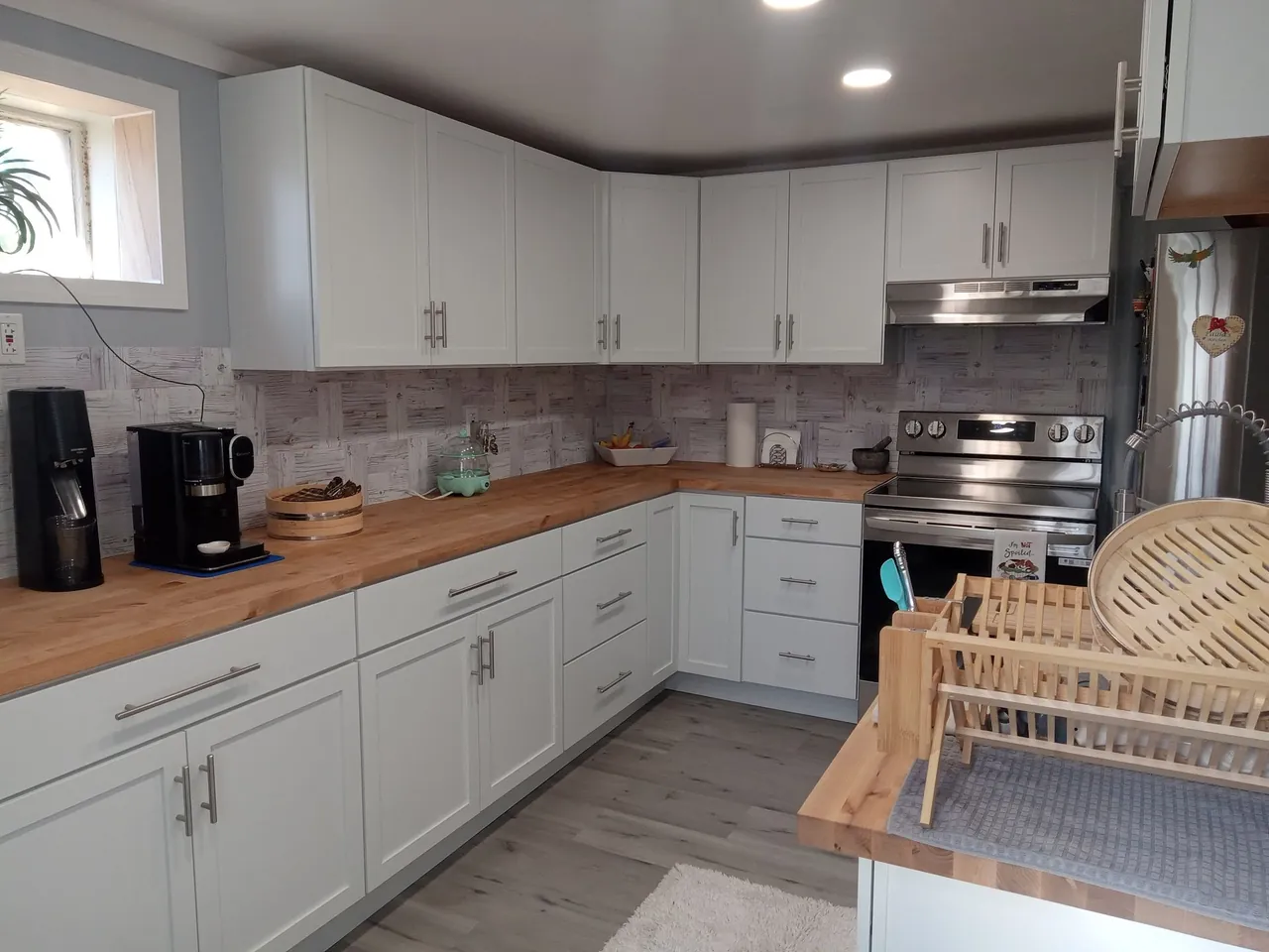 Kitchen interior with wood counters, tile backsplash, and finished floors